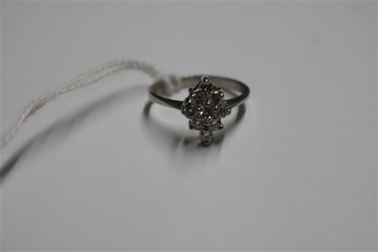 A platinum and lozenge shaped diamond cluster ring, size L/M.